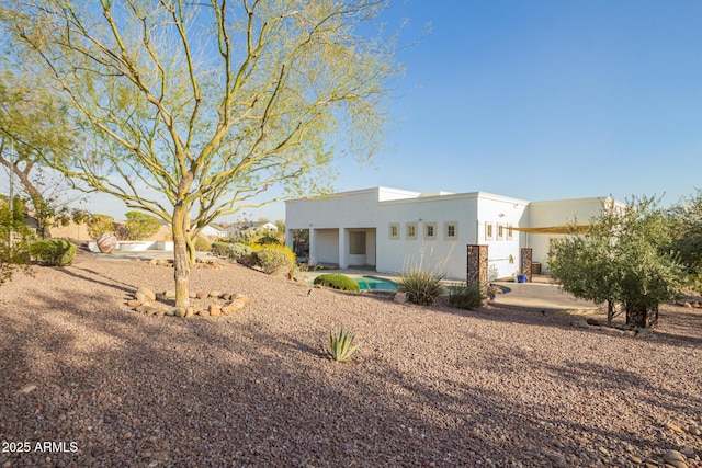 view of front of property featuring a patio and stucco siding