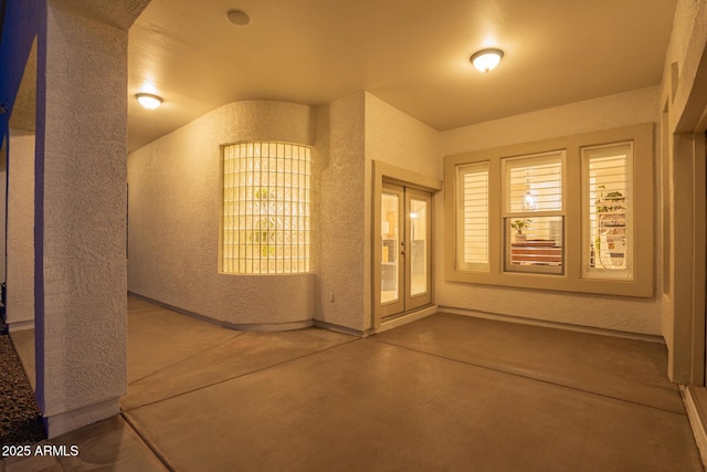 view of exterior entry featuring a patio area and french doors