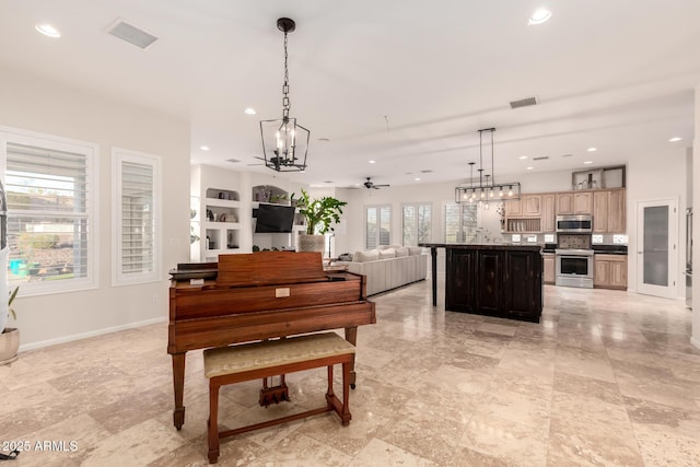 living area featuring baseboards, ceiling fan with notable chandelier, visible vents, and recessed lighting