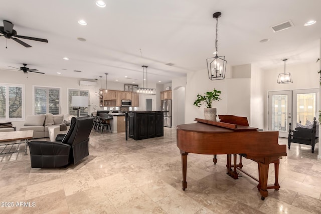 living area featuring arched walkways, recessed lighting, visible vents, french doors, and a wall mounted AC