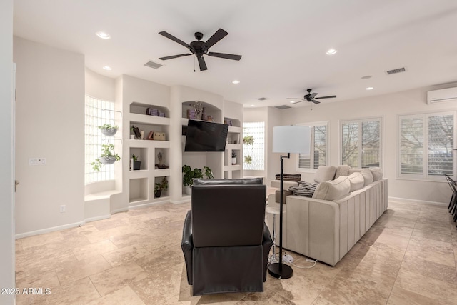 living area featuring baseboards, a wall mounted AC, visible vents, and recessed lighting