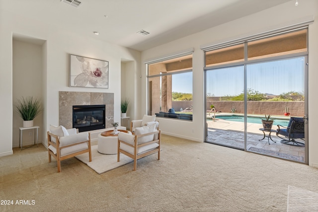 carpeted living room with a fireplace