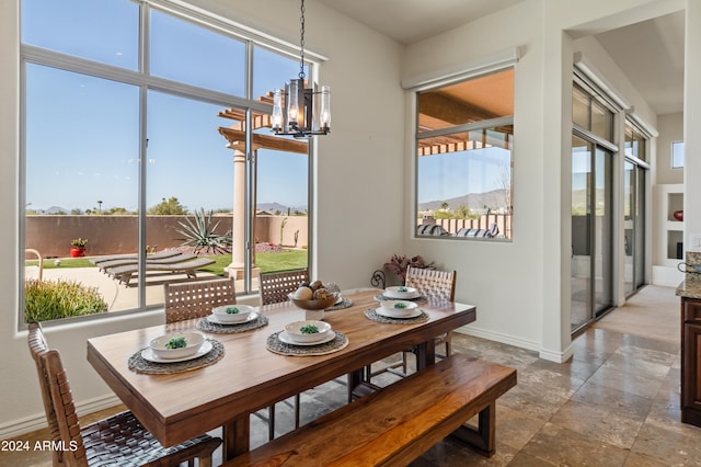 dining area with a notable chandelier and a healthy amount of sunlight