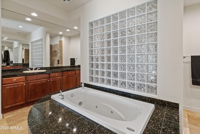 bathroom with vanity and independent shower and bath