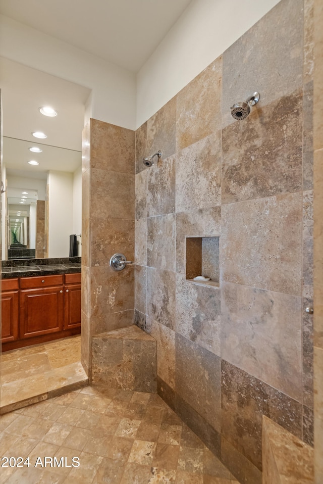 bathroom featuring vanity and a tile shower