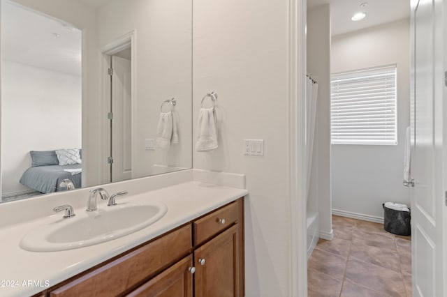 bathroom featuring vanity, shower / bathtub combination with curtain, and tile patterned flooring