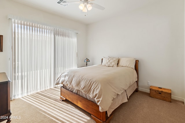 bedroom with ceiling fan and light colored carpet