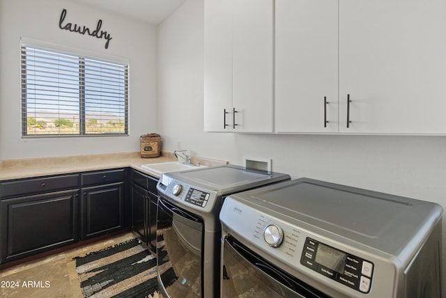 washroom featuring sink, cabinets, and separate washer and dryer