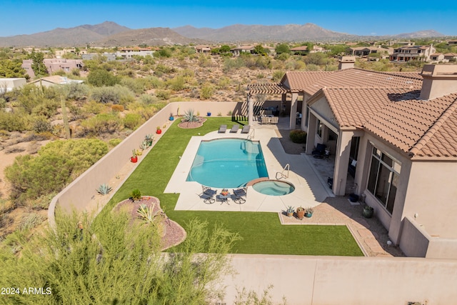 view of swimming pool with a yard, a patio, a pergola, a mountain view, and an in ground hot tub