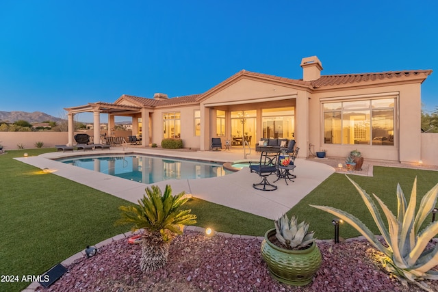 view of pool featuring a yard, a mountain view, a patio, and a pergola