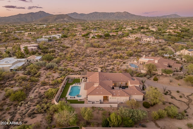 aerial view at dusk featuring a mountain view