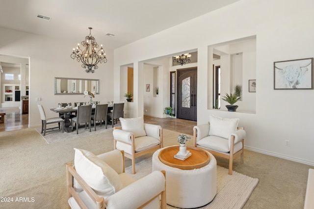 living room featuring light colored carpet and a chandelier