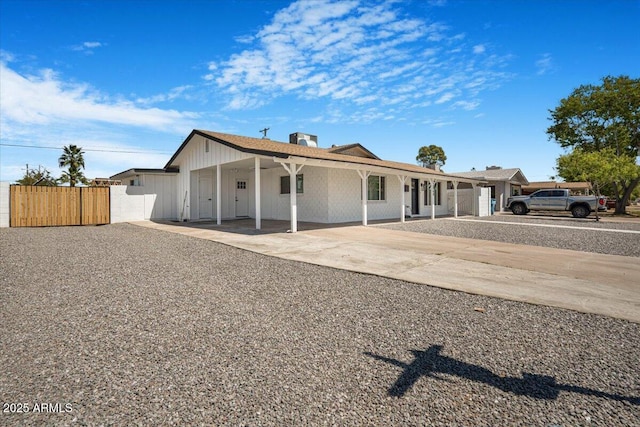 3846 W Cavalier Dr, Phoenix, AZ 85019 - view of front of property featuring an attached carport, board and batten siding, fence, a gate, and driveway