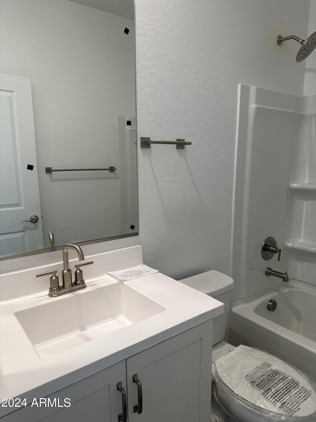 full bathroom featuring toilet, vanity, and bathing tub / shower combination