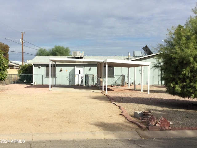 back of property with a carport