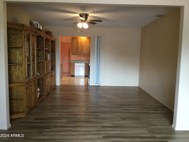 unfurnished dining area featuring dark wood-type flooring and ceiling fan