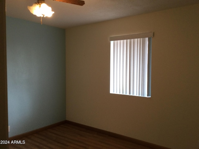 empty room featuring wood-type flooring and ceiling fan