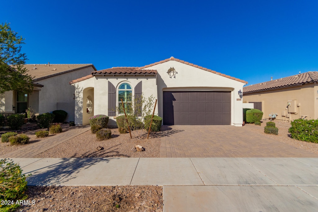 mediterranean / spanish house featuring a garage