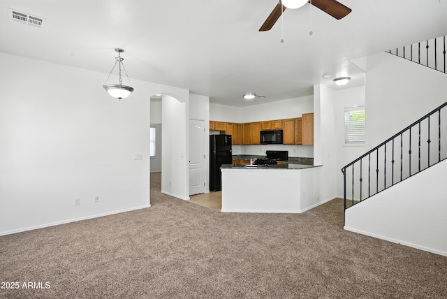 2109 E Fraktur Rd, Phoenix, AZ 85040 - kitchen with black appliances, light carpet, dark countertops, arched walkways, and open floor plan