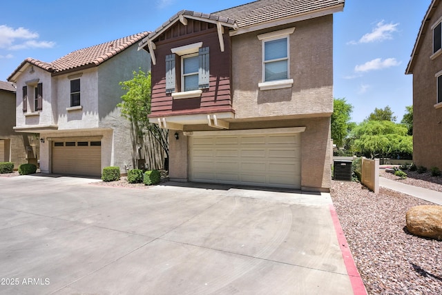 2109 E Fraktur Rd, Phoenix, AZ 85040 - view of front of house featuring an attached garage, driveway, stucco siding, and a tile roof