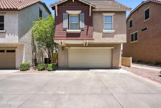 2109 E Fraktur Rd, Phoenix, AZ 85040 - view of front of house with stucco siding, driveway, an attached garage, and a tiled roof