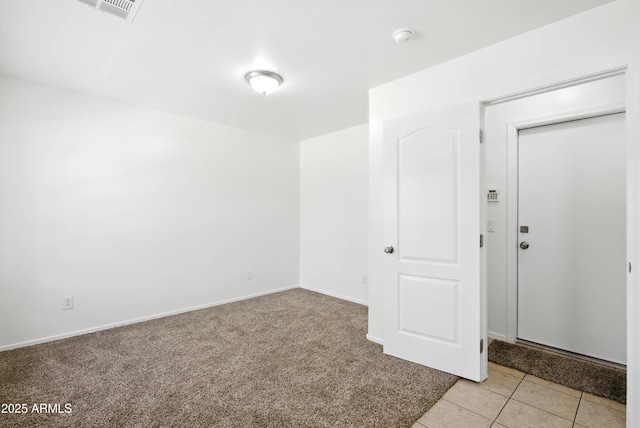 2109 E Fraktur Rd, Phoenix, AZ 85040 - empty room featuring light carpet, light tile patterned floors, and a smoke detector