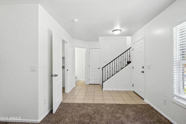 2109 E Fraktur Rd, Phoenix, AZ 85040 - foyer with light carpet, stairway, and light tile patterned flooring