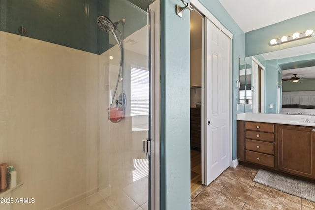 full bath featuring ceiling fan, vanity, and a walk in shower