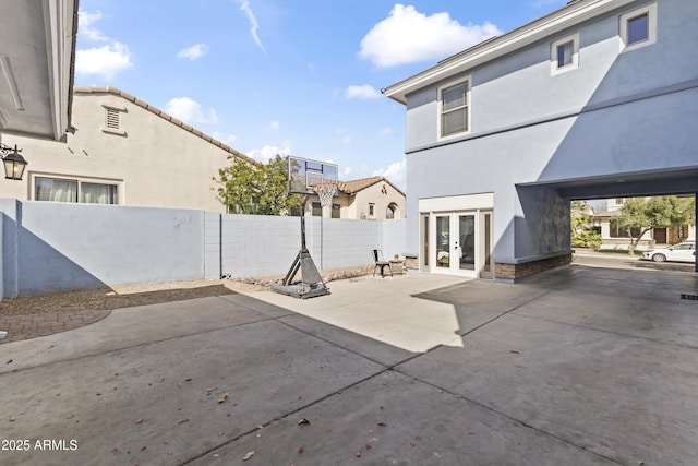 view of patio featuring french doors and fence