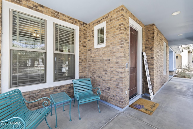 entrance to property featuring brick siding