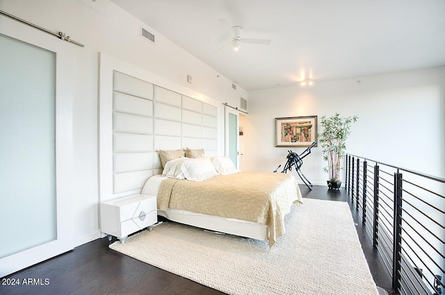 bedroom with ceiling fan and dark hardwood / wood-style floors