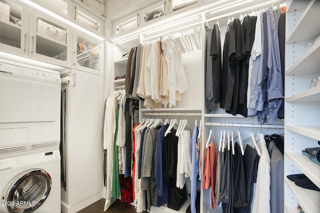 walk in closet featuring stacked washing maching and dryer