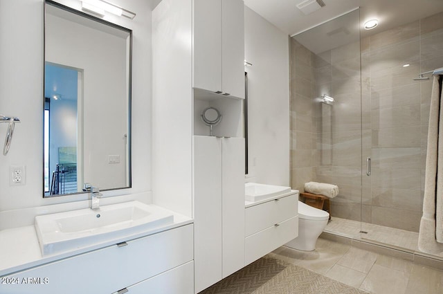 bathroom featuring tile patterned flooring, vanity, toilet, and an enclosed shower