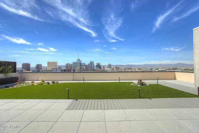 view of property's community featuring a lawn and a mountain view