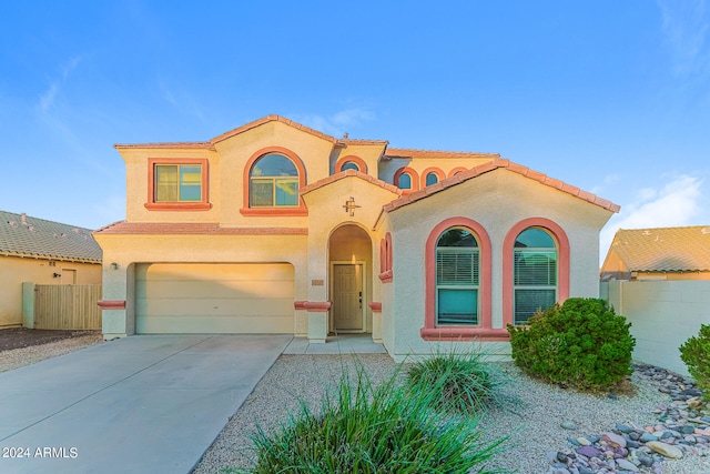 mediterranean / spanish-style house with a garage