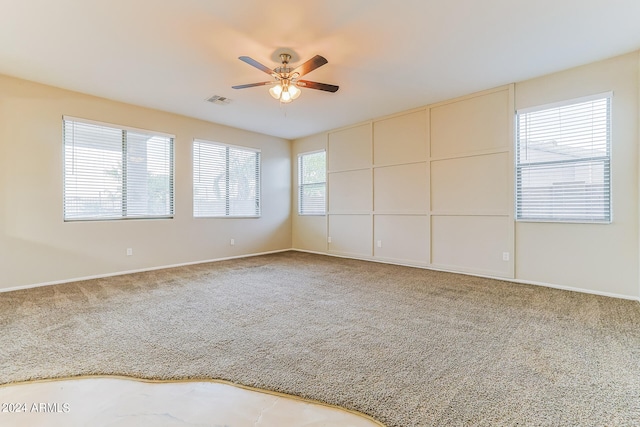 carpeted empty room featuring ceiling fan