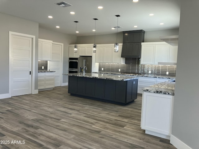 4079 E Roosevelt St, Apache Junction, AZ 85119 - kitchen featuring stainless steel appliances, backsplash, dark wood-style flooring, white cabinets, and recessed lighting