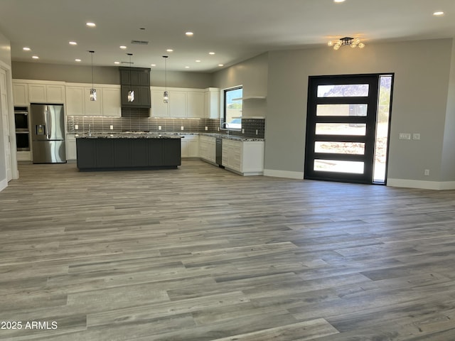 4079 E Roosevelt St, Apache Junction, AZ 85119 - kitchen with stainless steel appliances, white cabinets, open floor plan, backsplash, and recessed lighting