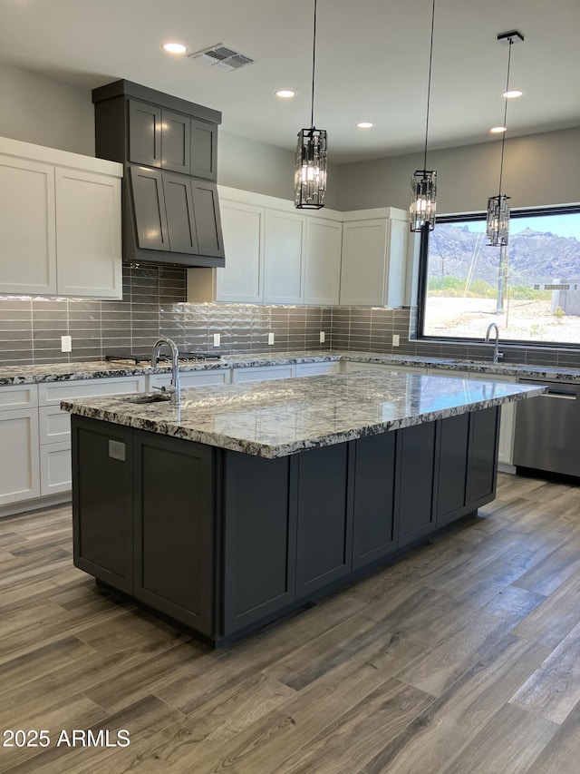 4079 E Roosevelt St, Apache Junction, AZ 85119 - kitchen featuring dishwasher, ventilation hood, tasteful backsplash, wood finished floors, and recessed lighting