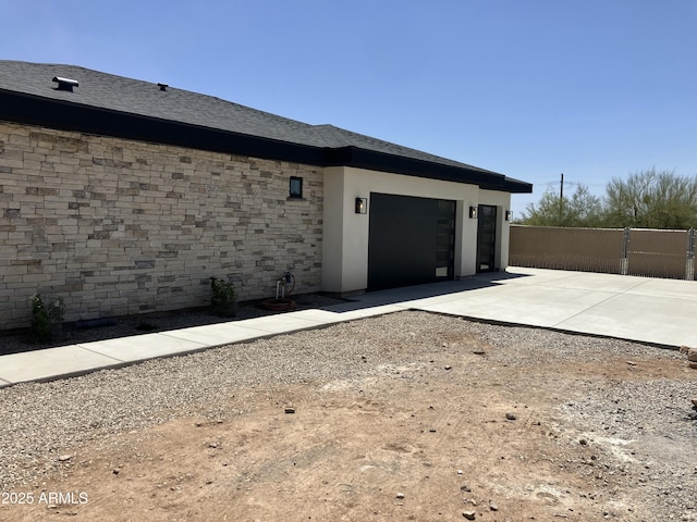 4079 E Roosevelt St, Apache Junction, AZ 85119 - view of side of home featuring a garage and driveway