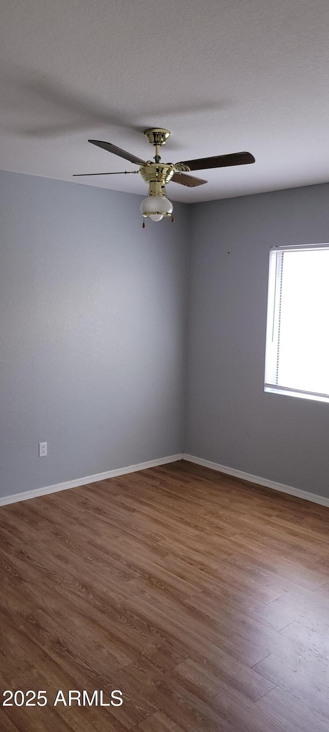 unfurnished room featuring wood-type flooring and ceiling fan