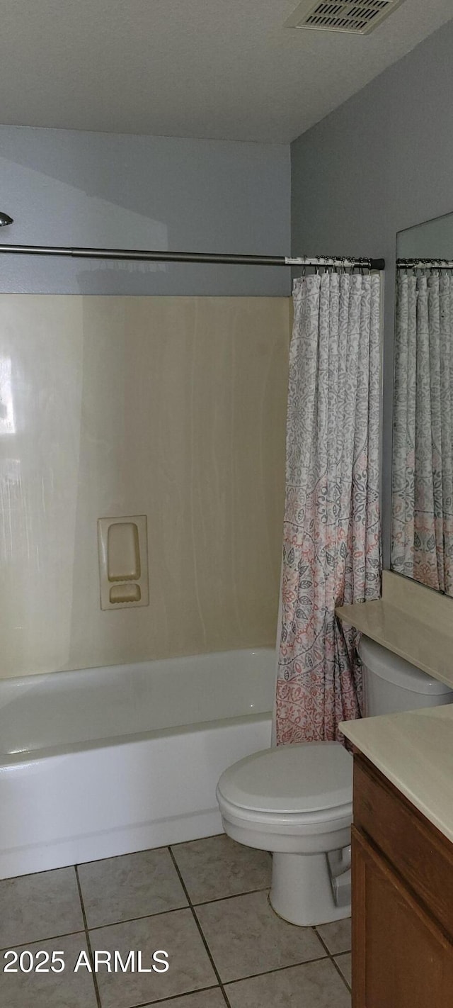 full bathroom with shower / tub combo, vanity, tile patterned floors, and toilet