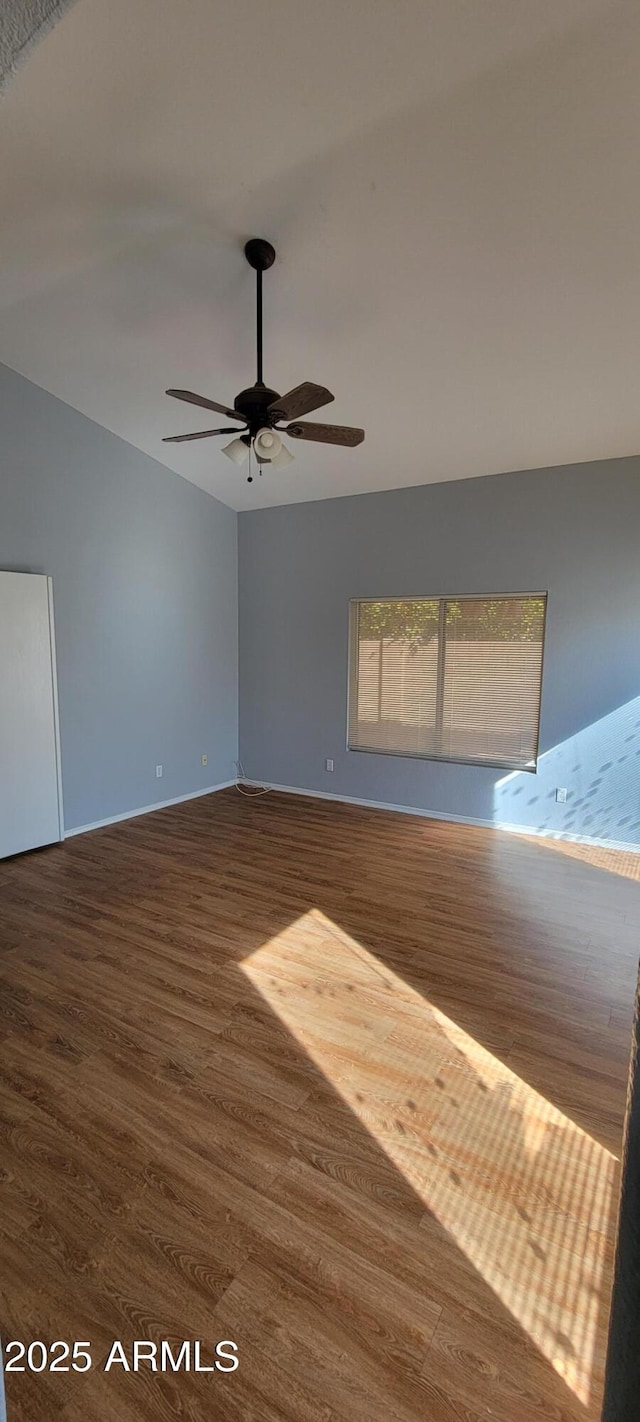 spare room featuring ceiling fan, lofted ceiling, and dark hardwood / wood-style flooring