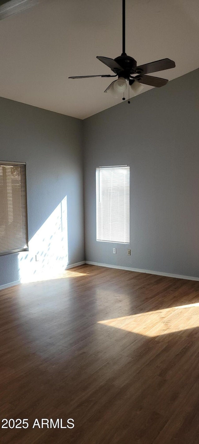 spare room featuring lofted ceiling, hardwood / wood-style floors, and ceiling fan