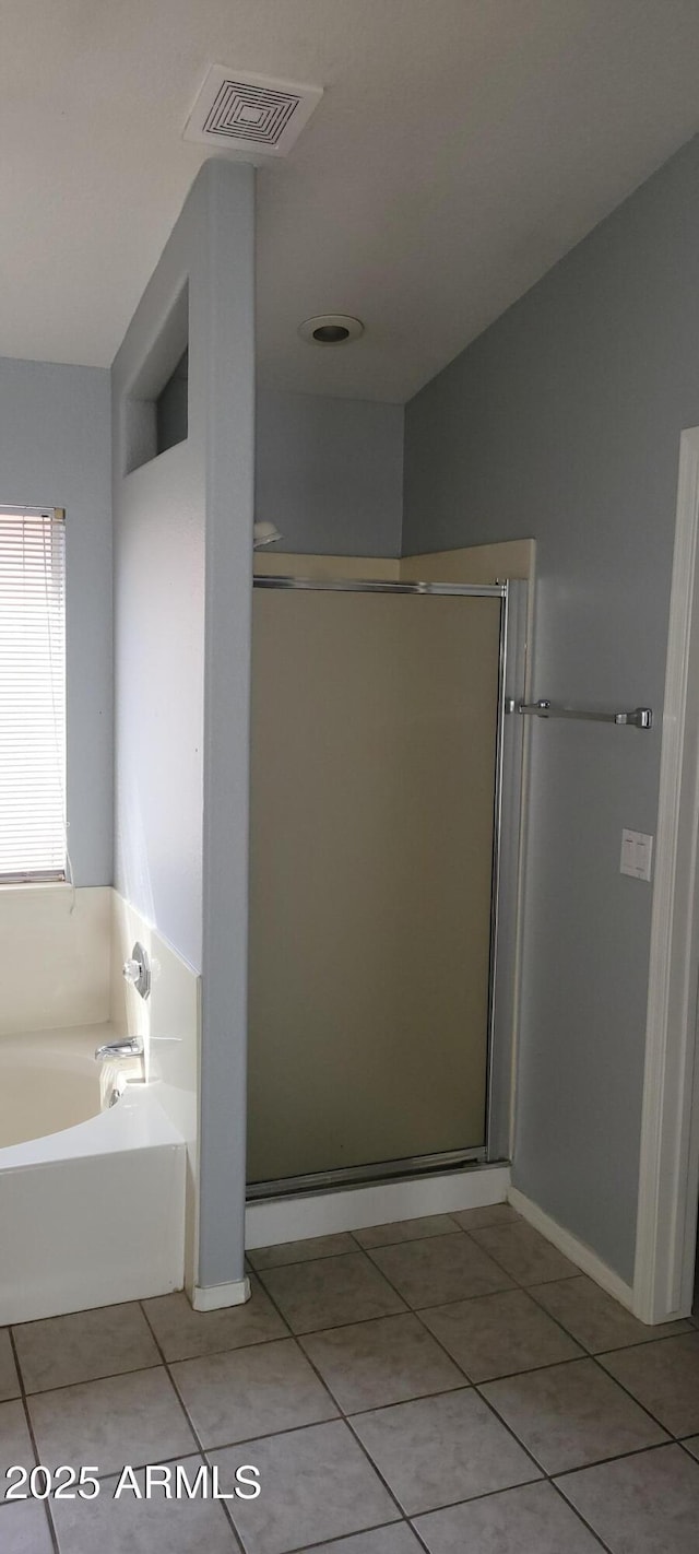 bathroom featuring plus walk in shower and tile patterned floors