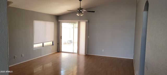 unfurnished room with ceiling fan, vaulted ceiling, and hardwood / wood-style floors