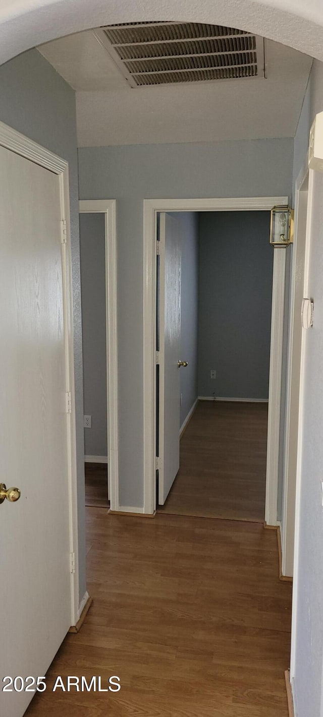 corridor with wood-type flooring