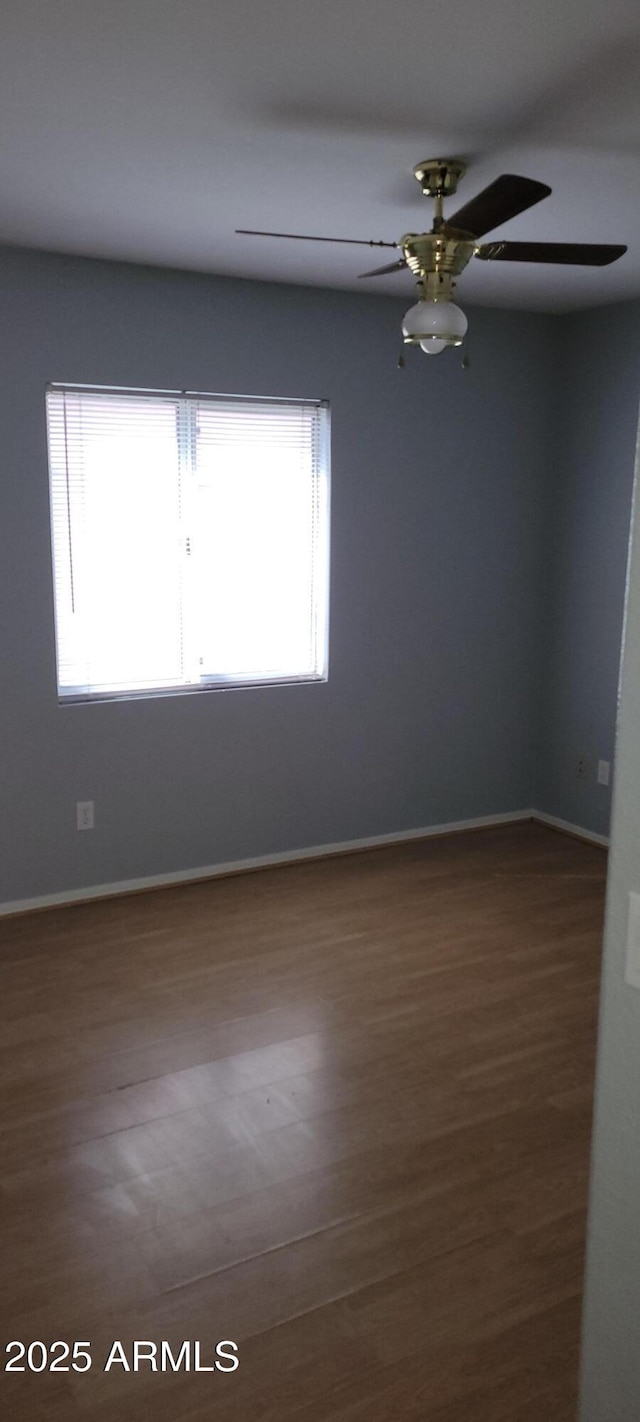 spare room with hardwood / wood-style floors, a healthy amount of sunlight, and ceiling fan