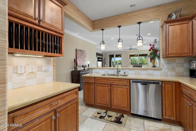 kitchen featuring crown molding, backsplash, hanging light fixtures, sink, and stainless steel dishwasher