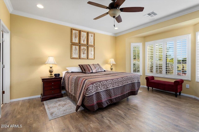 bedroom with ornamental molding, wood-type flooring, and ceiling fan